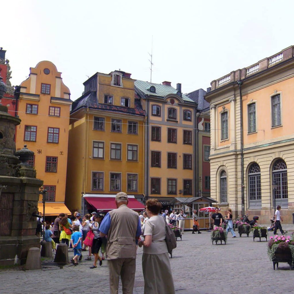 An image of tourists visiting senior Sweden travel spots.