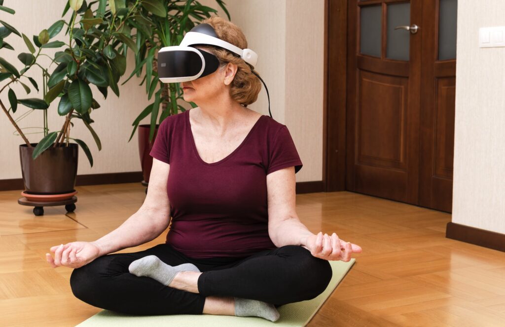 a woman sitting on a mat with a vr headset on her face