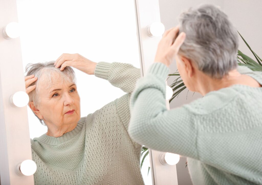 Hormonal changes reduce natural oils, leading to dryness and fragile hair.