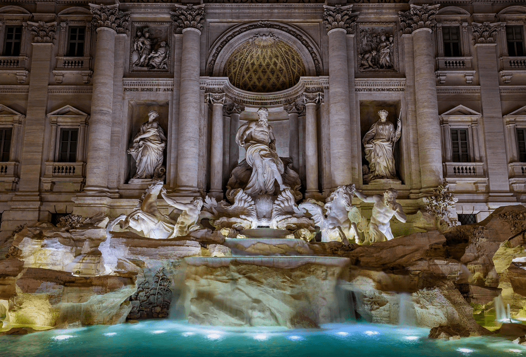 An image of the Trevi Fountain in Rome during the evening. 
