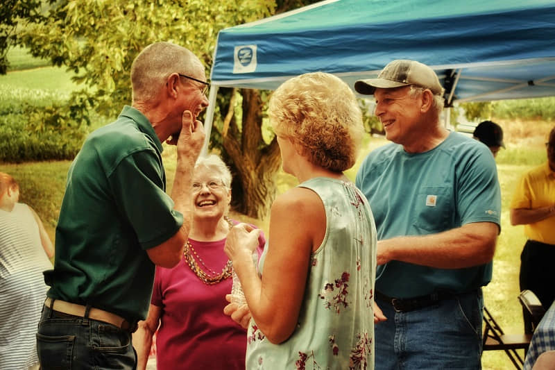 Older friends laughing together at a gathering