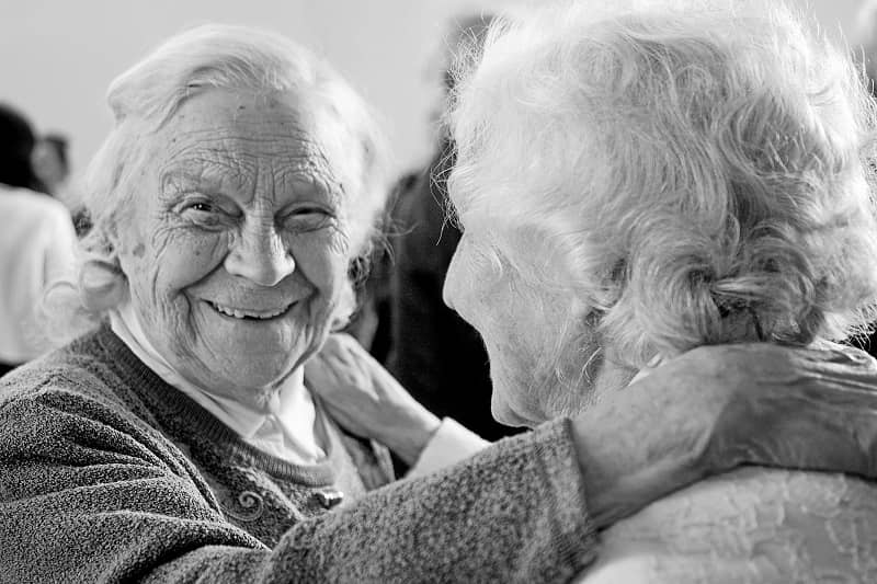 Two older friends sharing coffee