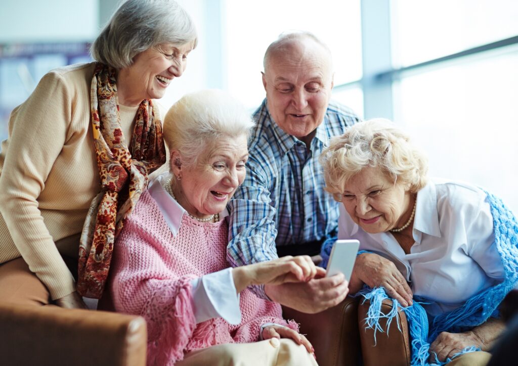 seniors looking at a phone laughing