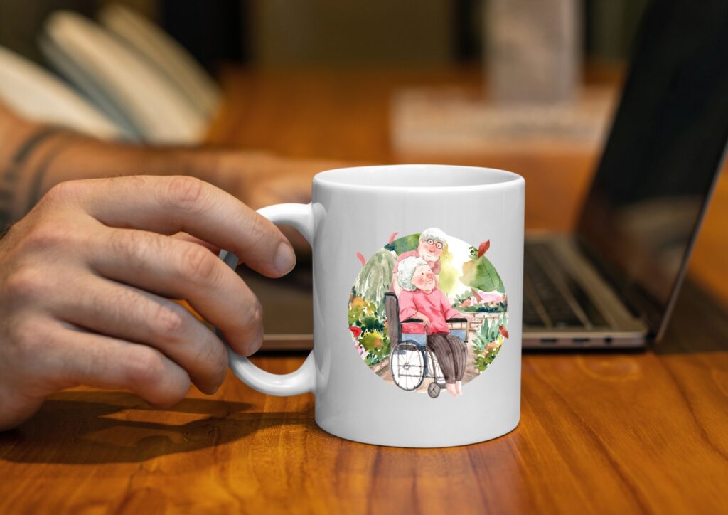 Hand holding a white mug with a hand-painted design of an elderly couple, one in a wheelchair, in a garden setting.