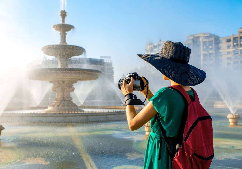 A senior with a sun hat touring Bucharest