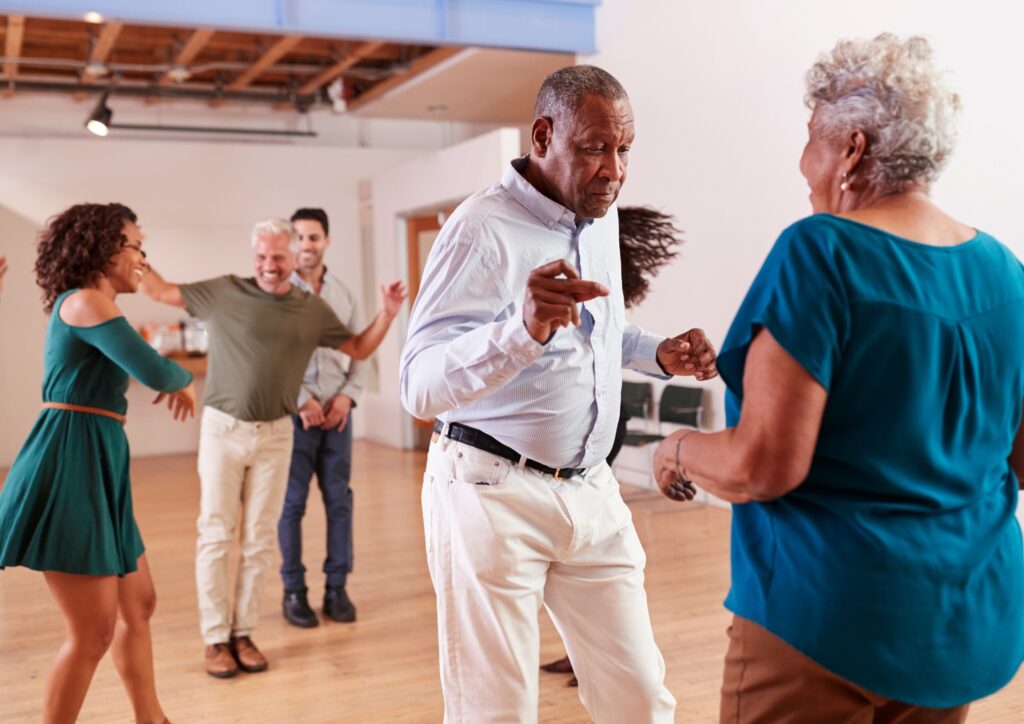 a group of senior happily dancing. 