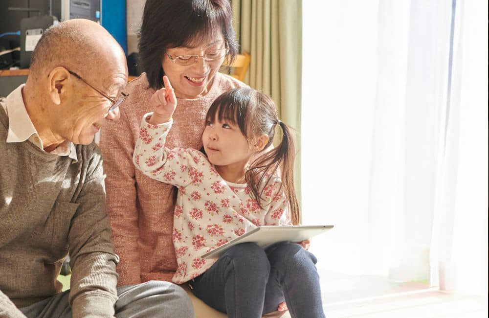 An image of grandparents with their grandchild.