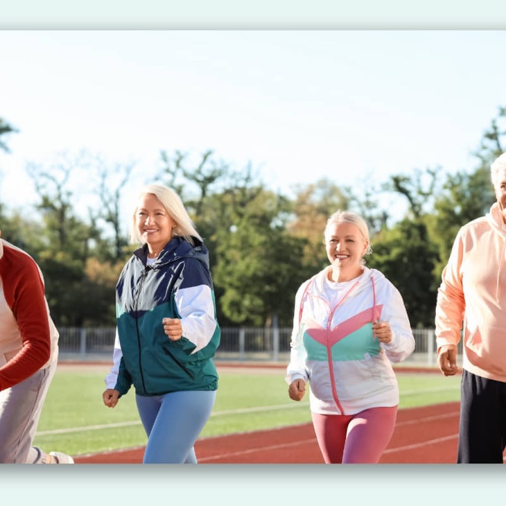 An image of seniors on a track field jogging